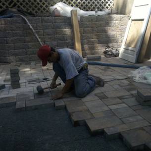 How to Lay Pavers Pounding Pavers Into Place